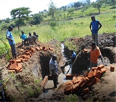 Volunteers constructing a clean water well in a rural community