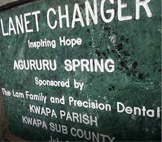 Planet Changer sponsorship sign at Agururu Spring community water project