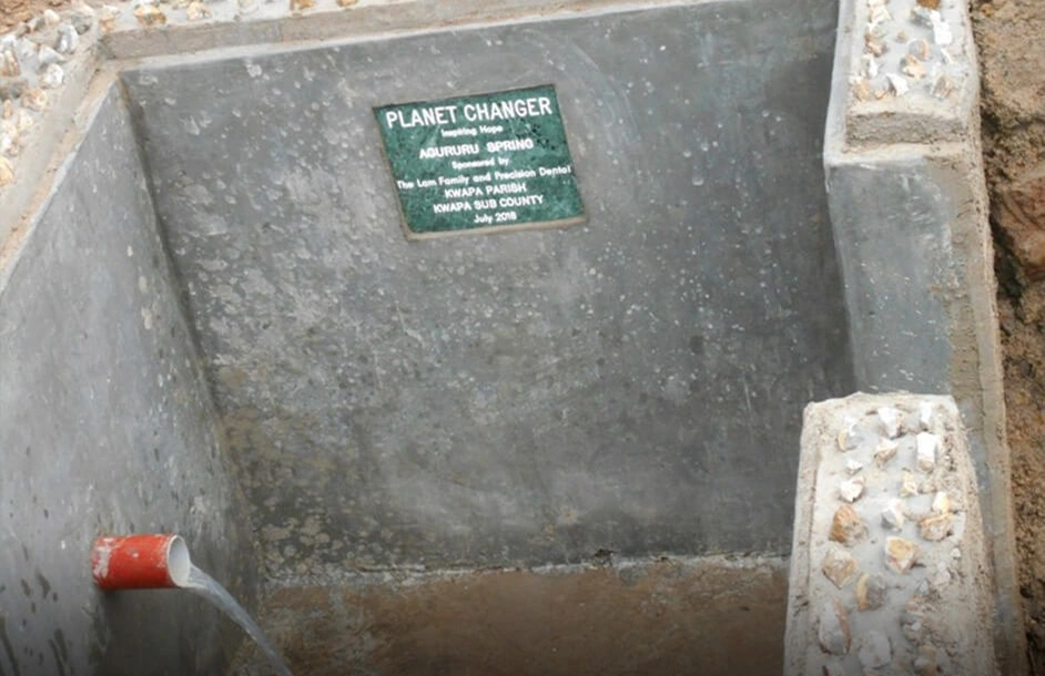 Completed clean water well serving a community in Uganda