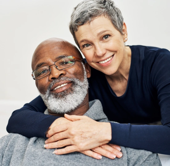 Smiling older couple enjoying the benefits of dental implants