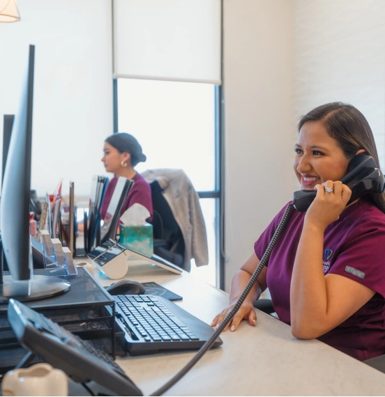Staff assisting a patient with insurance and financing