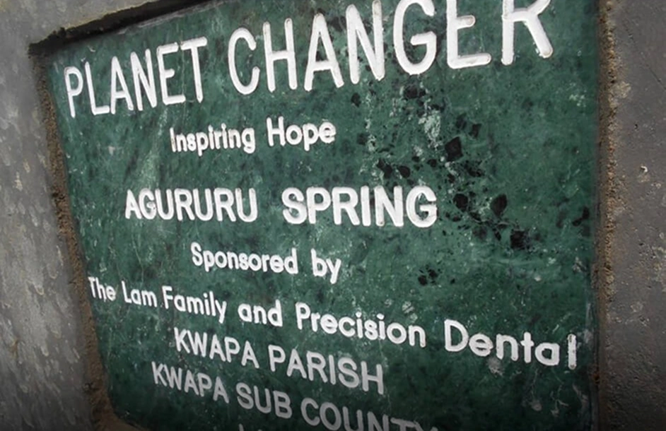 Sign marking the Planet Changer clean water project in Uganda