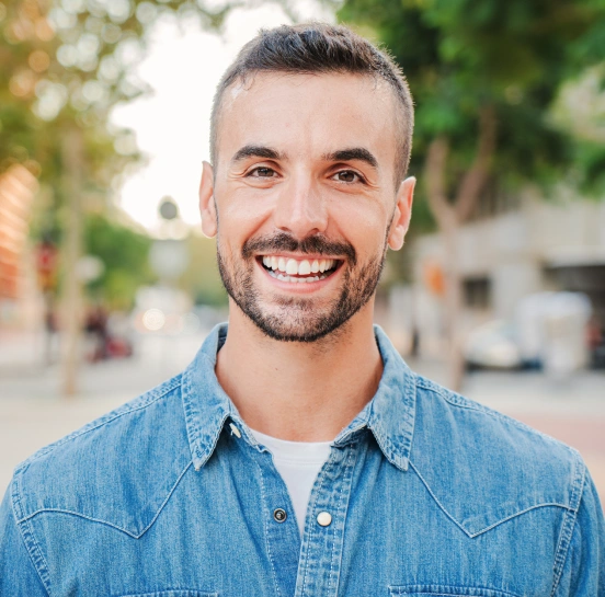 Man smiling after restorative dental treatment