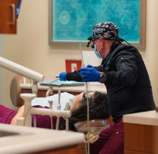 Dentist performing a root canal procedure to save a damaged tooth