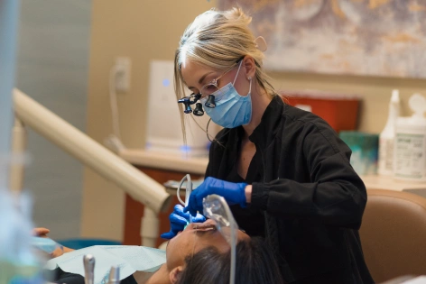 Dentist performing a root canal procedure using rotary endodontic technology