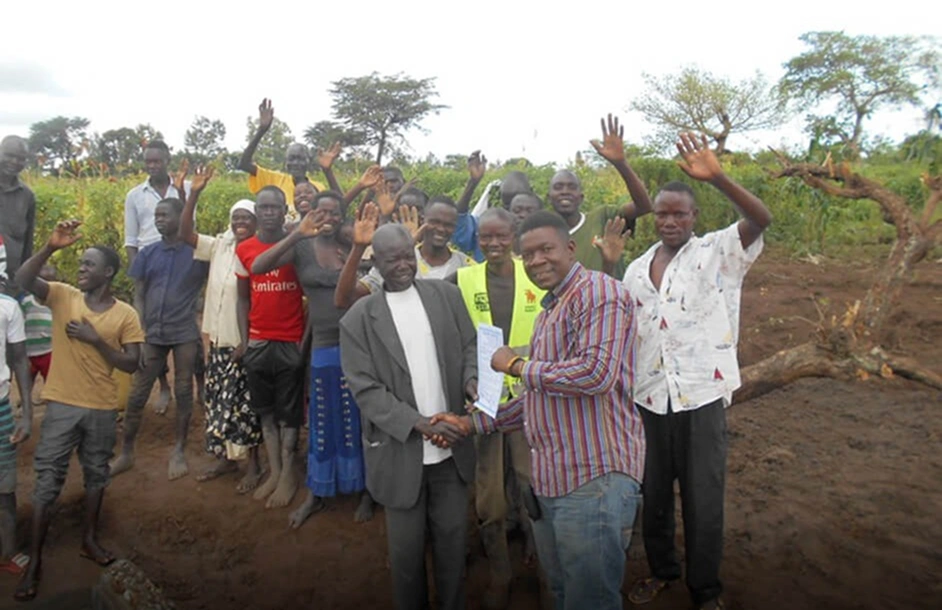Community members celebrating the completion of a clean water project